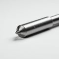 A close-up of a metal precision tool, possibly a carbide tip or center drill. The object is Royalty Free Stock Photo