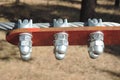 Close-up of metal ropes held together by clamps and bolts, steel wire rope and metal clamp are part of structure of rope park