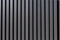A close up of a metal wall with vertical lines. AI generative image
