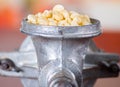 A close up from a metalic mill with some corn kernels Royalty Free Stock Photo