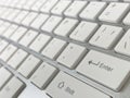 Close up of metallic grey keyboard and white keyboard focus at enter button of a modern technology