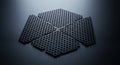 Close-up of a metallic hexagon grid pattern with small hexagonal cells arranged on a dark black background from elevated angle Royalty Free Stock Photo