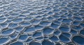 Close-up of metallic hexagonal honeycomb pattern reflecting light Royalty Free Stock Photo