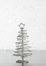 Close-up of metallic modern christmas tree on wood table Royalty Free Stock Photo