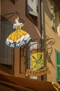 Close-up of a metallic street shop sign in a building at GrÃÂ©oux-les-Bains village.
