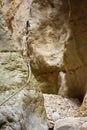 close up of a metallic string to climb a vertical white stone of the wall of a mountain helping to hikers to save the gap to get