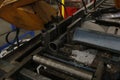 A close-up of a metalworking machine in operation, cutting through metal with precision, surrounded by metal shavings