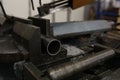 A close-up of a metalworking machine in operation, cutting through metal with precision, surrounded by metal shavings