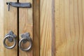Close-up of Mexican style of furniture, showing aged wood, iron lock handle and knobs in rings.