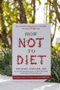 Michael Greger\'s How Not To Diet book in the garden. Diet book.