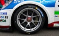 Close up of Michelin slick racing tire on Porsche Carrera car, side view motorsport Royalty Free Stock Photo