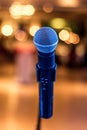 Close up of microphone in concert or conference hall with blurred lights at background Royalty Free Stock Photo