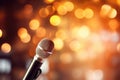 Close up of microphone in concert hall with blurred lights at background. Garland lamps or flashlights in a blurry bokeh Royalty Free Stock Photo