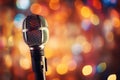 Close up of microphone in concert hall with blurred lights at background. Garland lamps or flashlights in a blurry bokeh Royalty Free Stock Photo