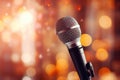 Close up of microphone in concert hall with blurred lights at background. Garland lamps or flashlights in a blurry bokeh Royalty Free Stock Photo