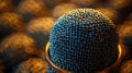 Close-up microphone grid detail on recording studio desk with bokeh background Royalty Free Stock Photo