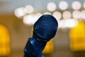 A close up of a microphone in a hall or a conference room, Microphone on a blurred background as in a speech in a seminar room Royalty Free Stock Photo