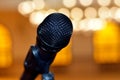 A close up of a microphone in a hall or a conference room, Microphone on a blurred background as in a speech in a seminar room Royalty Free Stock Photo
