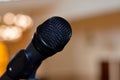 A close up of a microphone in a hall or a conference room, Microphone on a blurred background as in a speech in a seminar room Royalty Free Stock Photo