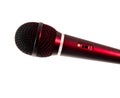 Close-up of a microphone illuminated by red stage lighting, showing an on-off switch, symbolizing audio equipment, performance, Royalty Free Stock Photo