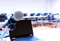 Close up microphone with laptop on table background in seminar room Royalty Free Stock Photo