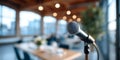 Close-up of microphone in modern conference room with blurred background and warm lighting for presentation or speech Royalty Free Stock Photo