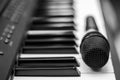 Close up microphone on piano keyboard in music studio. Royalty Free Stock Photo