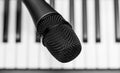 Close up microphone on piano keyboard in music studio. Royalty Free Stock Photo