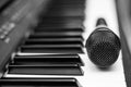 Close up microphone on piano keyboard in music studio. Royalty Free Stock Photo