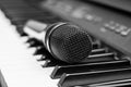 Close up microphone on piano keyboard in music studio. Royalty Free Stock Photo