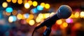 Close-Up Microphone on Stage with City Lights Bokeh Background Royalty Free Stock Photo