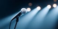 Close-up of a microphone on a stand illuminated by stage spotlights in a dark environment with blurred background Royalty Free Stock Photo