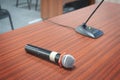 Close up Microphone on the table, concept of speaker or teacher preparation to speak in seminar class room.