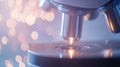 Close up of microscope lens in laboratory with blurred background lights Royalty Free Stock Photo