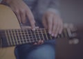 Close up of mid section of a person playing a guitar Royalty Free Stock Photo