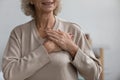 Middle aged woman thanking God with folded hands on heart. Royalty Free Stock Photo