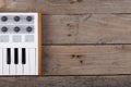 Close up of MIDI controller volume fader, knob and keys.