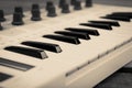 Close up of MIDI controller volume fader, knob and keys. Royalty Free Stock Photo