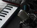 Close-up. MIDI keyboard, microphone, headphones. Modern equipment for a recording studio, a workplace for a musician, singer, Royalty Free Stock Photo