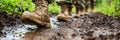 Close-up of military boots walking through mud and water during field training exercise. Royalty Free Stock Photo