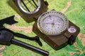 Close-up of a military compass on a map of Russia. Determining the direction of the compass Royalty Free Stock Photo