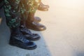 Close-up of military legs wearing black leather shoes, copy space available, selectable focus outdoors