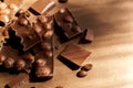 Close up of milk chocolate with hazel nuts on brown background. Copy spcace for text Royalty Free Stock Photo