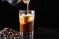 close-up of milk pouring into iced coffee with splashes Royalty Free Stock Photo