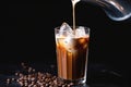 close-up of milk pouring into iced coffee with splashes Royalty Free Stock Photo