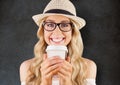 Close up of millennial woman smiling with coffee against grey grunge wall Royalty Free Stock Photo