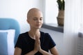 Close up mindful hairless woman joining hair in prayer
