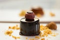 Close-up of mini dark chocolate mousse cake with french macaron topping, biscuit and almond crumbs styled on plate.