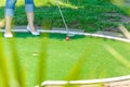 Close-up Mini Golf hole with bat and ball Royalty Free Stock Photo