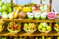 close up Miniature clay figurine Thailand`s floating market,Miniature boat carrying tropical fruit on wood background. Royalty Free Stock Photo